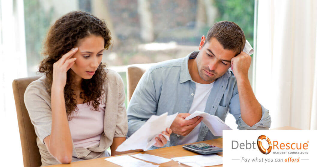 Couple looking at their finances and seem worried that they have hit financial rock bottom