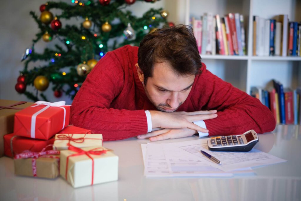 Man worried and without money for buying christmas present. Debt Holiday.