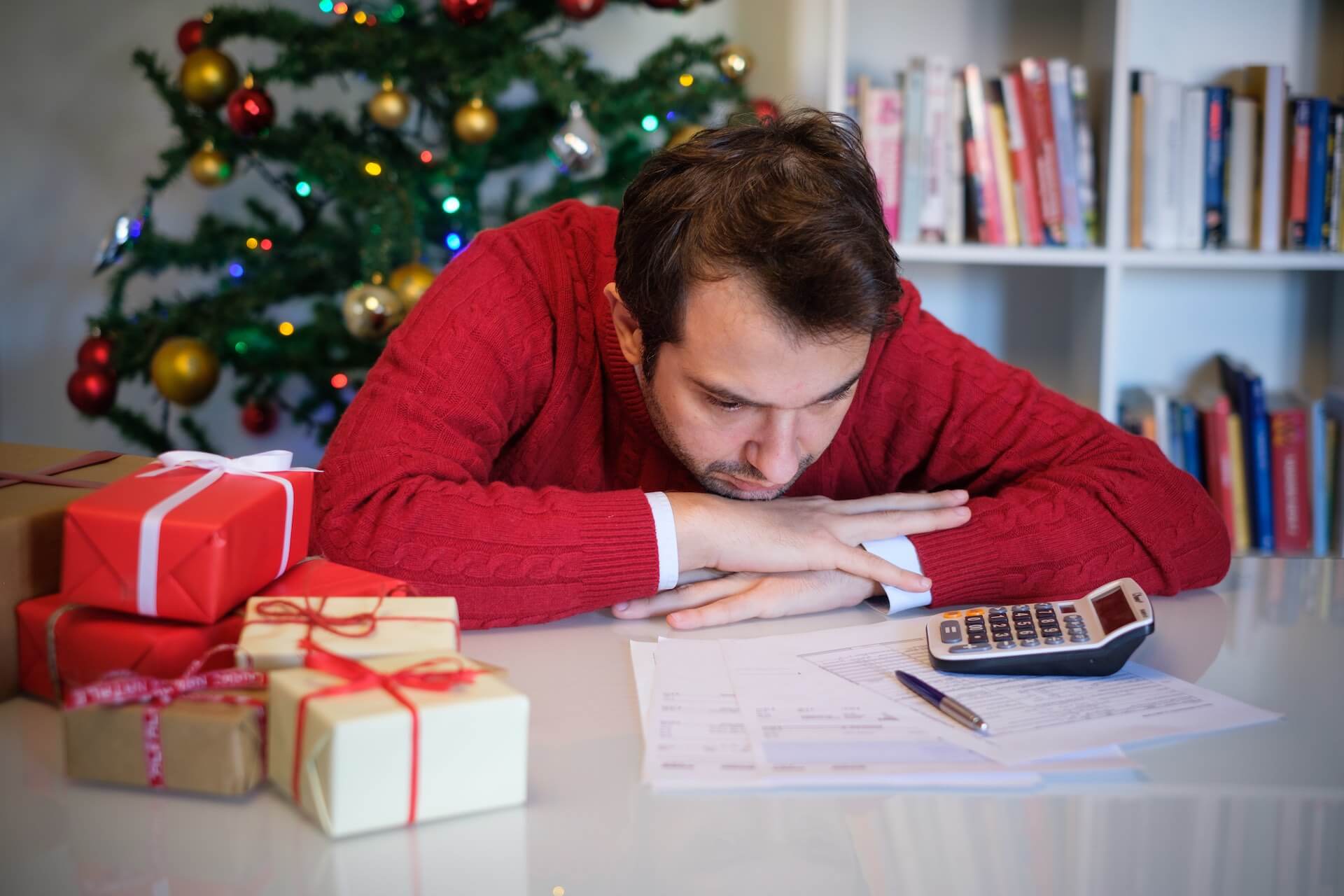 Man worried and without money for buying christmas present. Debt Holiday.